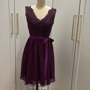 Short, wine colored, girl’s/woman’s fancy dress.
